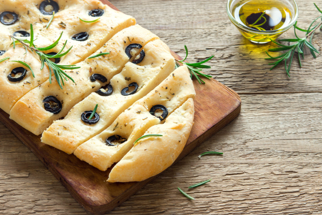 Traditional Focaccia with black olives and rosemary - homemade flat bread focaccia